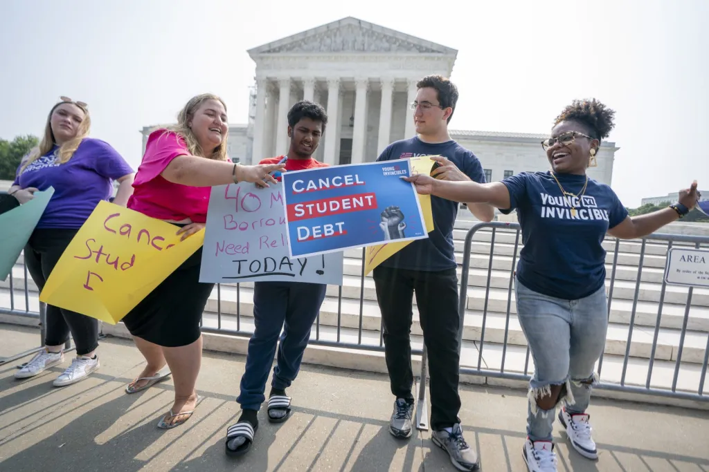 Activistas muestran mensajen de respaldo a la legalidad del plan del Gobierno de Joe Biden para cancelar la deuda estudiantil de millones de estudiantes universitarios, frente al Tribunal Supremo de EE.UU., este 30 de junio de 2023, en Washington. EFE/Shawn Thew