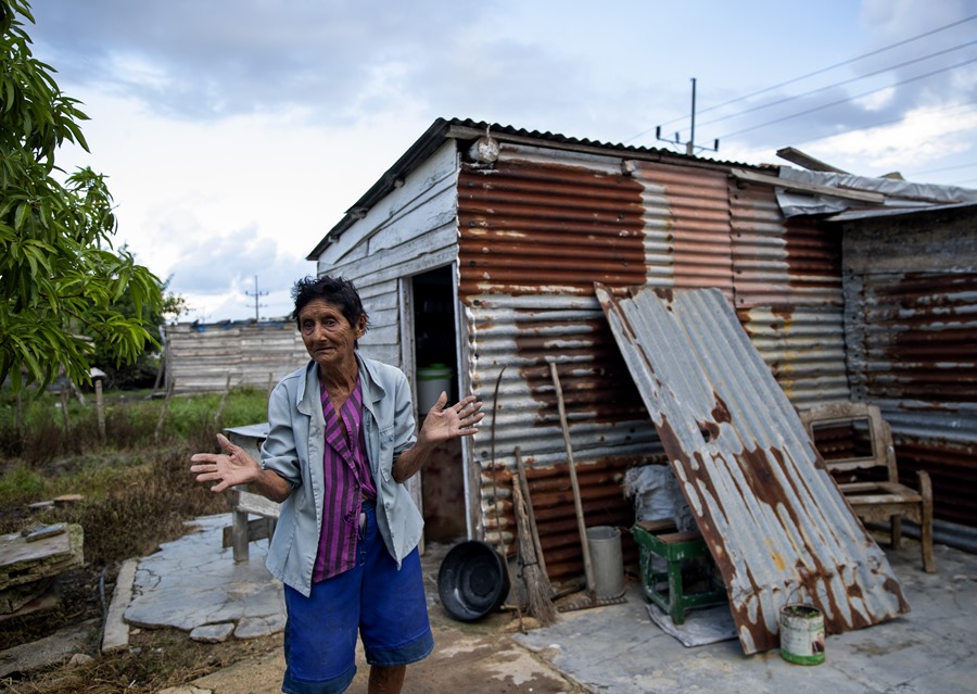 Gregoria Fernández, damnificada por el paso del huracán Ian, frente a su vivienda aún afectada, en la localidad La Coloma (provincia de Pinar del Río, Cuba). EFE/Yander Zamora