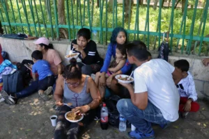 Migrantes comparten alimentos en un campamento, el 17 de septiembre de 2023 en Tapachula, Chiapas (México). EFE/Juan Manuel Blanco